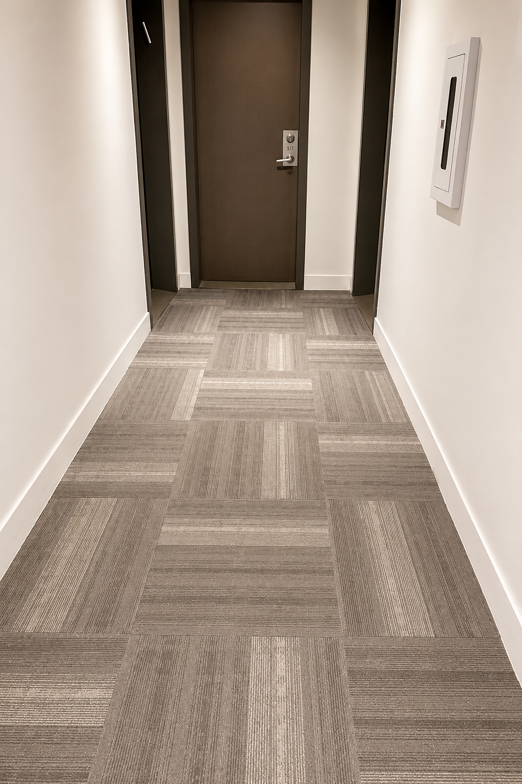 Clean condo hallway with carpeted flooring.